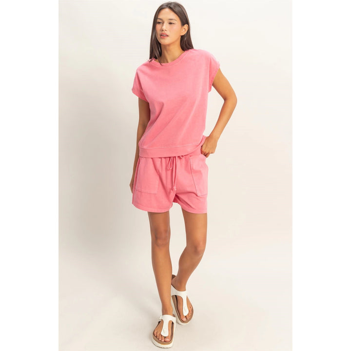 Woman wearing a pink outfit on a white background