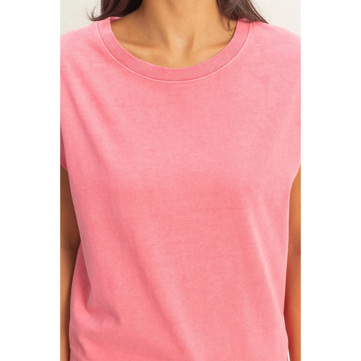 Pink sleeveless top worn by a person on a white background