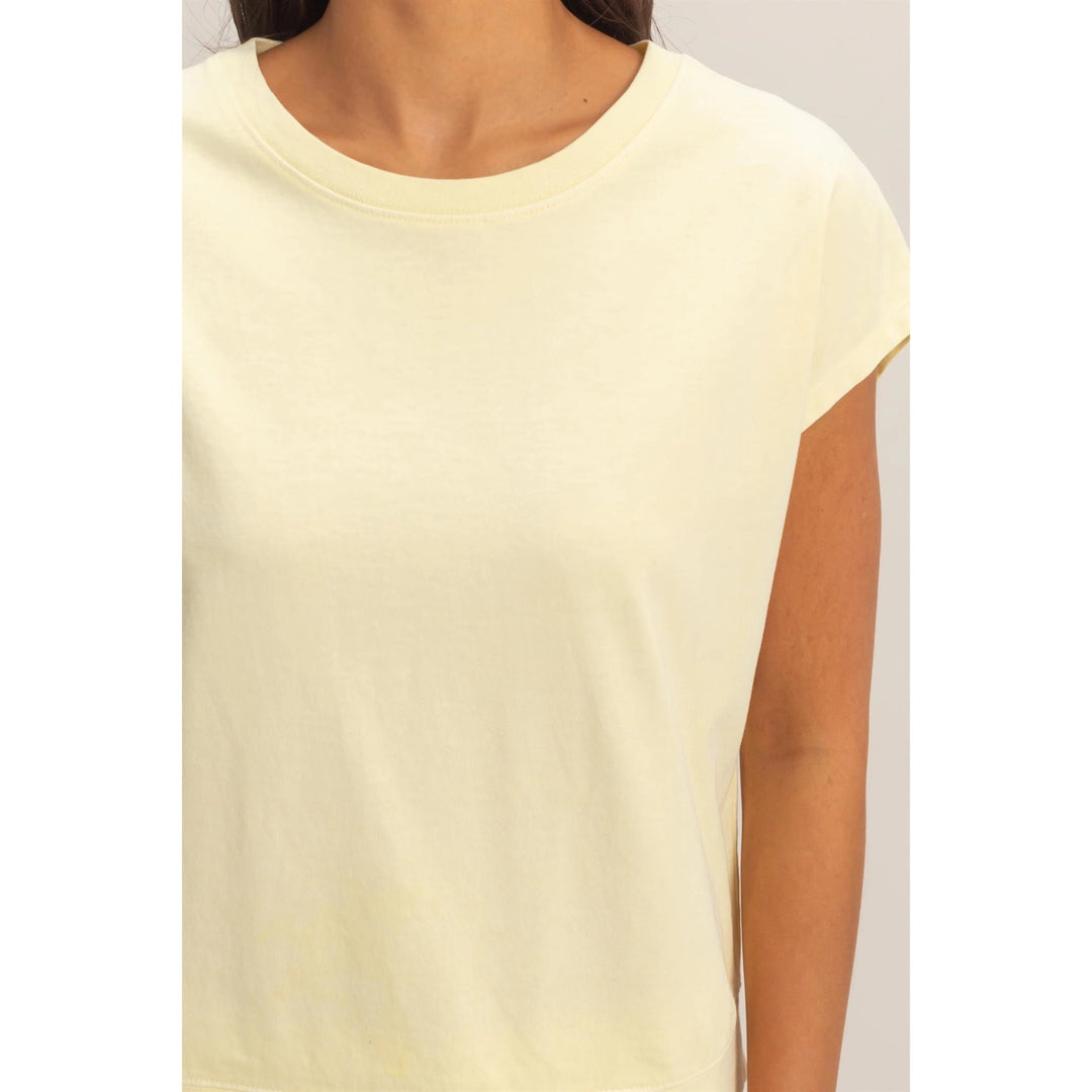 Light yellow sleeveless top worn by a person on a plain background