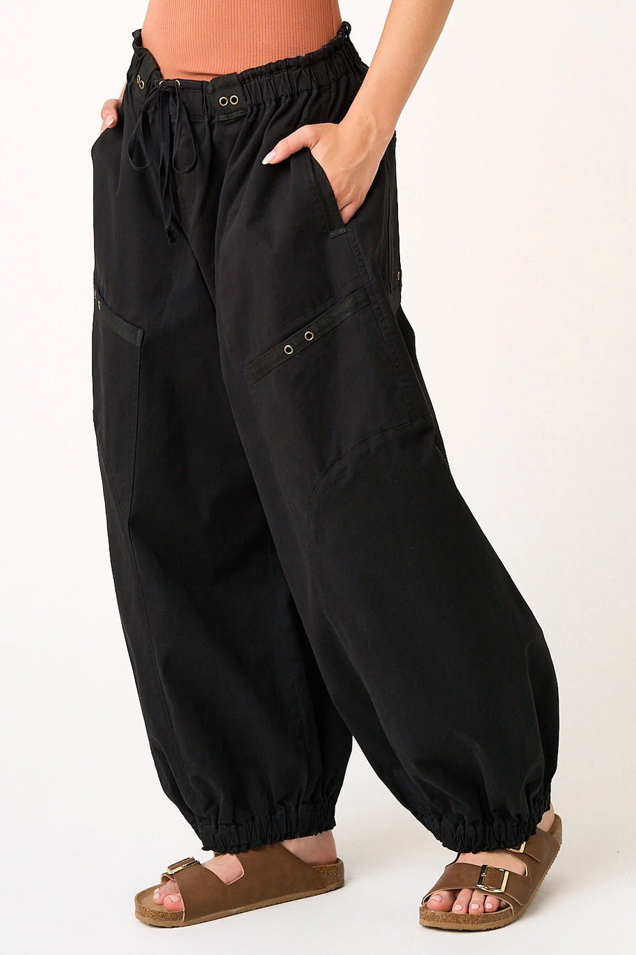 Black wide-leg pants worn by a person on a white background