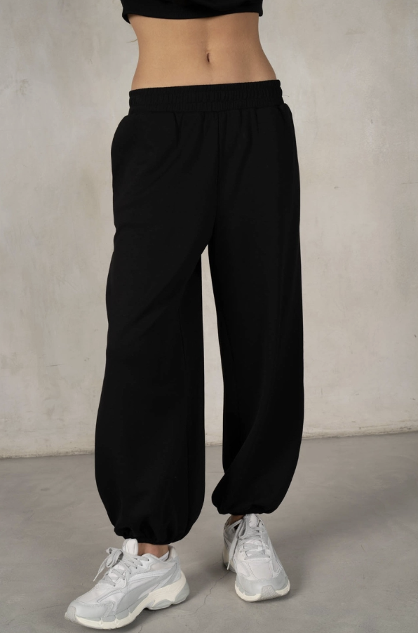 Black wide-leg pants worn by a person on a plain background