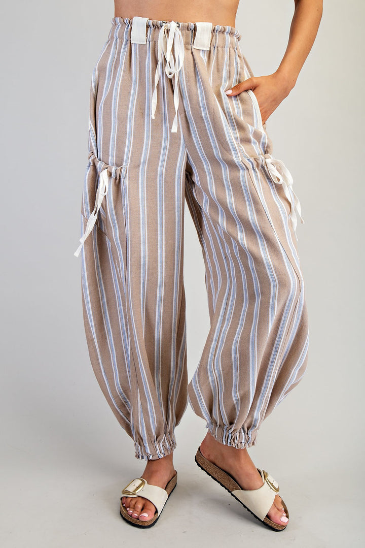 Striped pants worn by a person on a plain background
