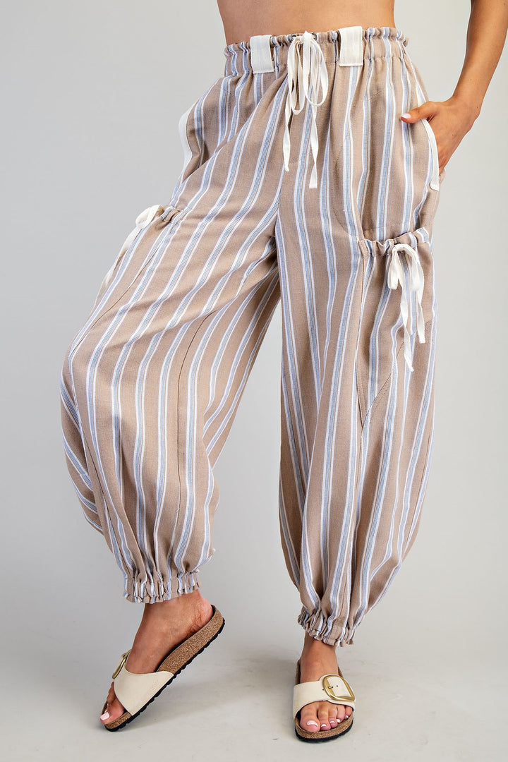 Striped pants worn by a person on a plain background