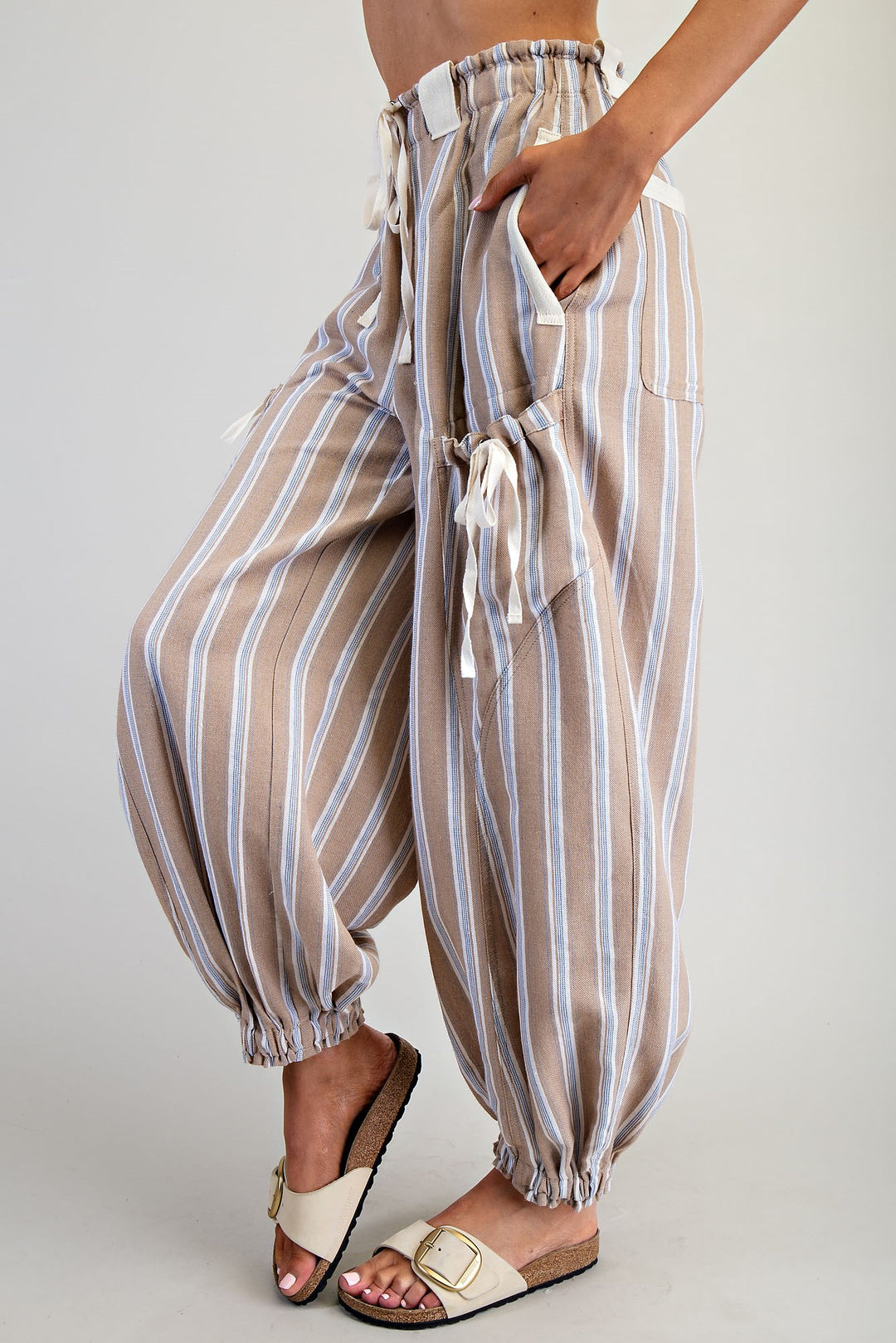 Striped pants worn by a person on a plain background