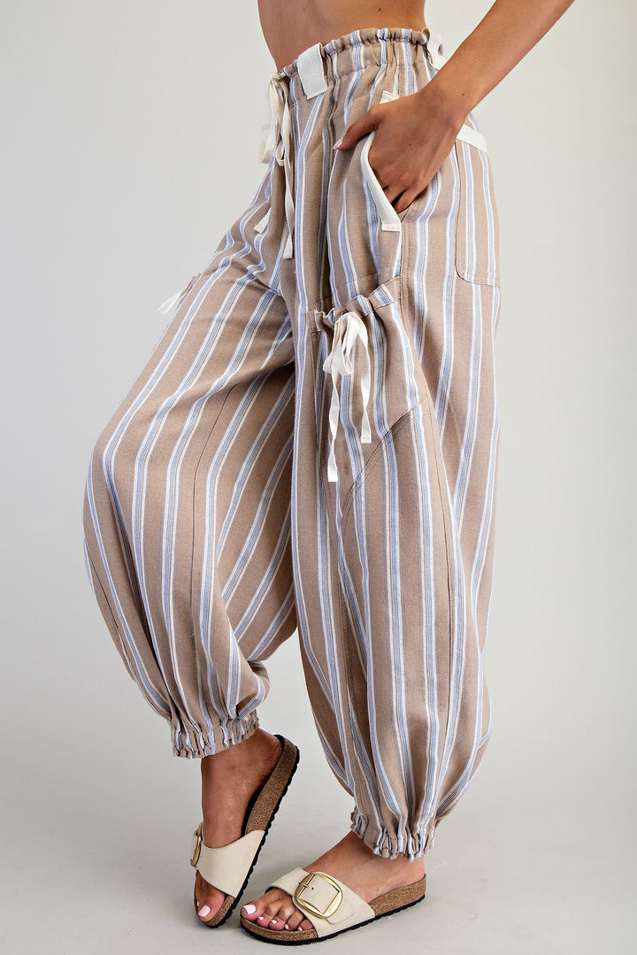 Striped pants worn by a person on a plain background