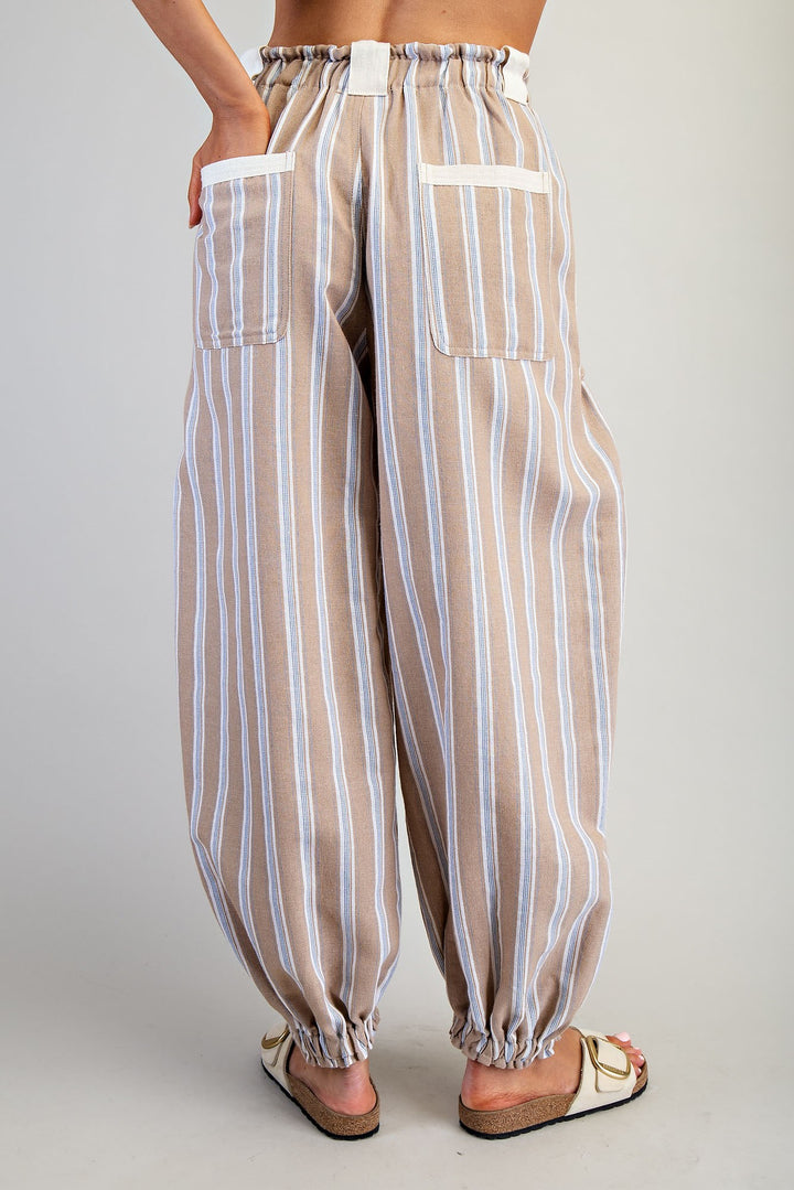 Striped pants worn by a person on a plain background