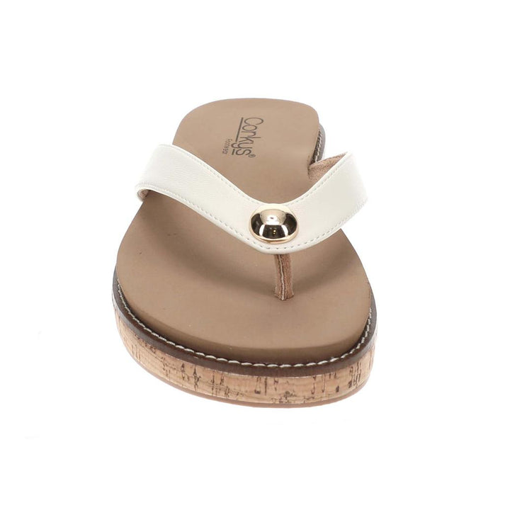 Brown sandal with white strap on a plain background