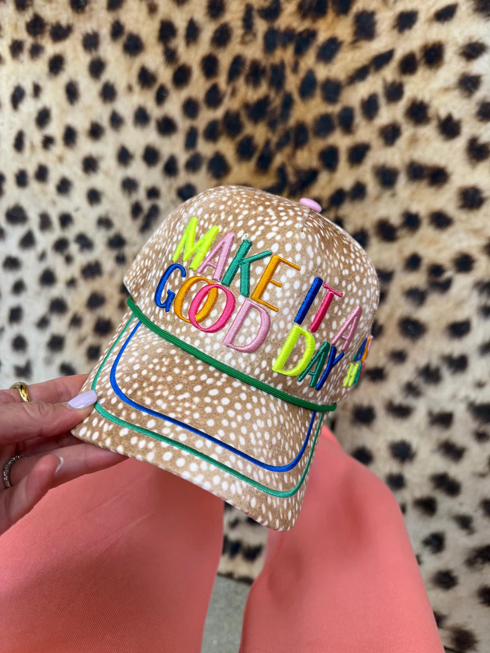 Trucker hat with fawn print and 'make it a good day' on front