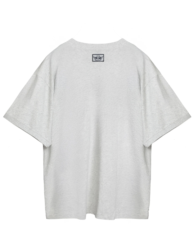 A light gray heather oversized short-sleeve t-shirt shown from the back, featuring a small black and white Adidas trefoil logo patch centered below the neckline, set against a plain white background.