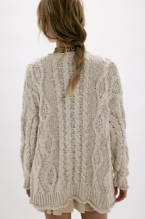 Woman wearing beige cardigan on white background