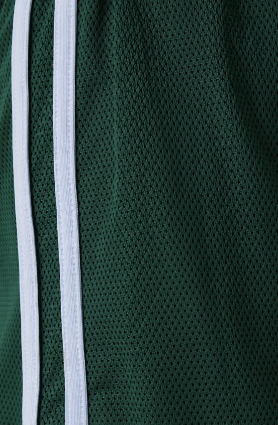 Close-up of a green sports jacket with white zipper and trim