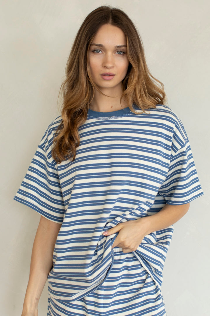 Woman wearing blue and white stripe set on plain background