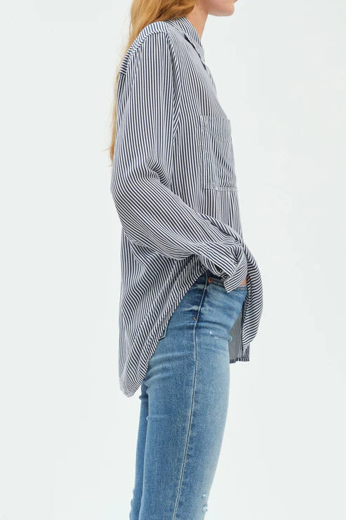 Person wearing a striped shirt and jeans on a white background