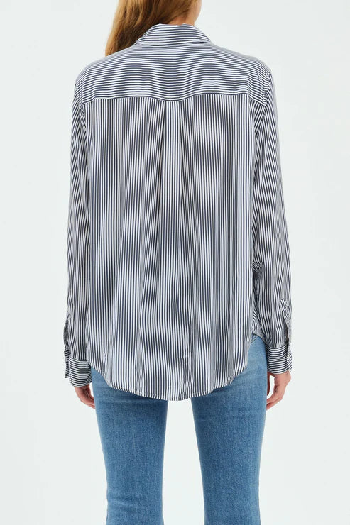 Person wearing a striped shirt and blue jeans on a white background