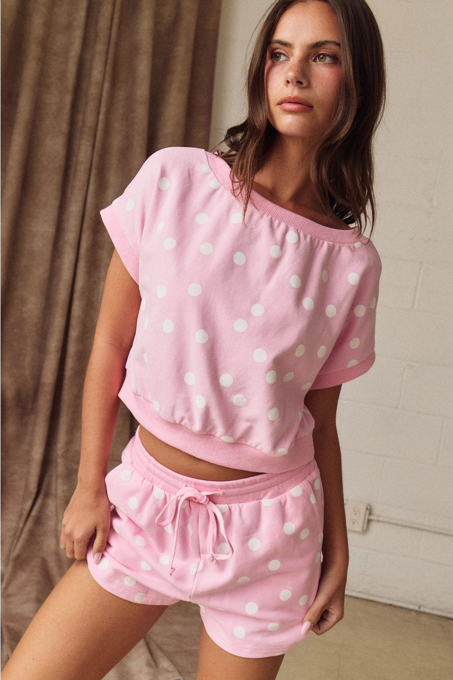 Woman wearing pink polka dot matching set 