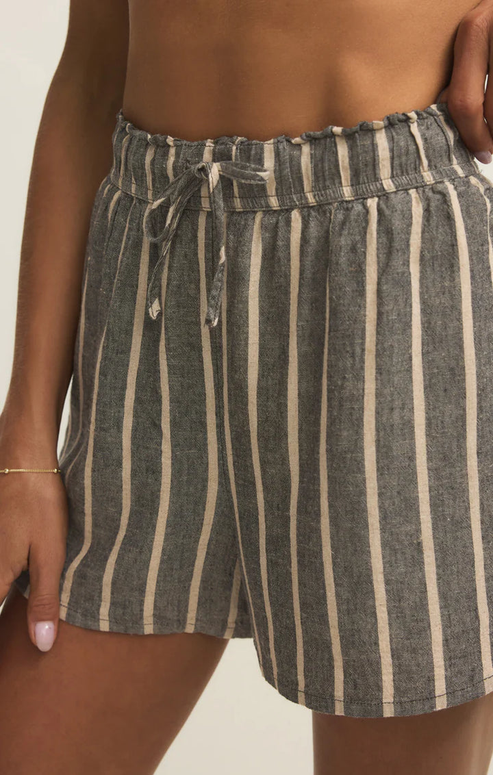 Striped shorts worn by a person on a plain background