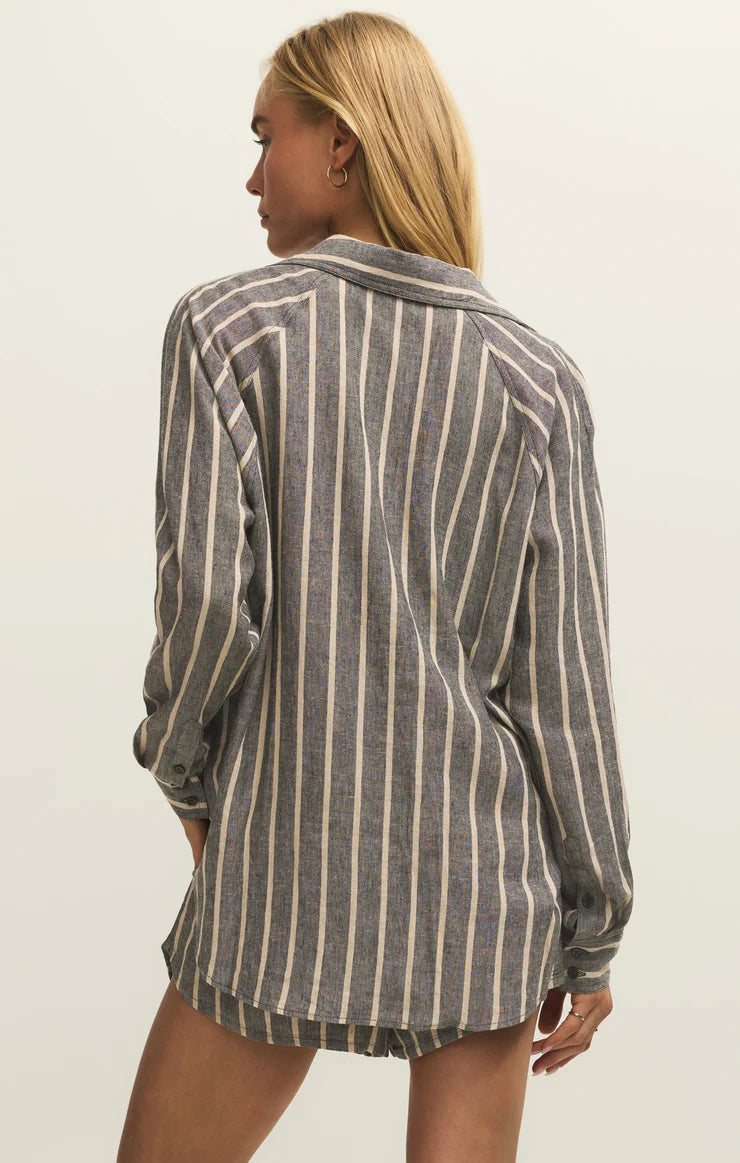 Person wearing a striped shirt against a plain background