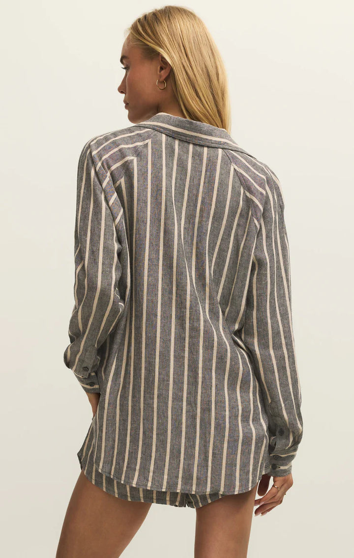 Person wearing a striped shirt against a plain background