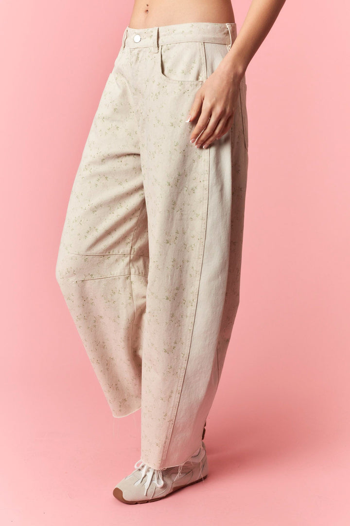 Beige pants worn by a person on a pink background
