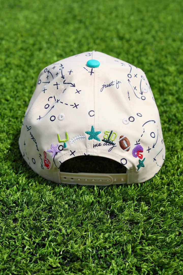 Back of trucker hat with football embroidery sitting on grass