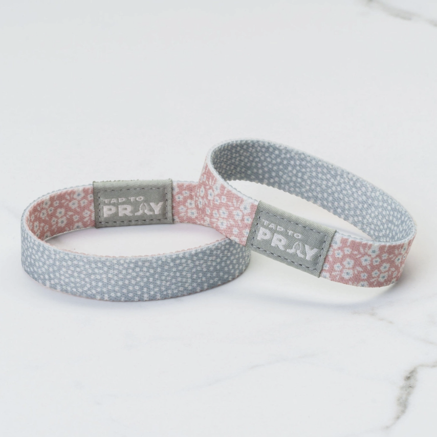 Two wristbands with floral patterns and &