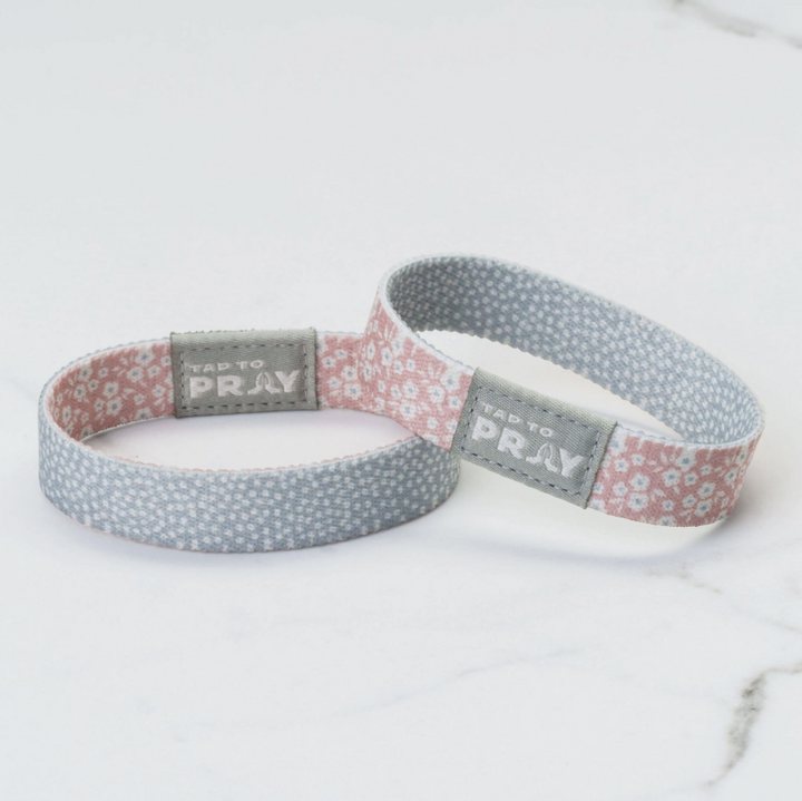 Two wristbands with floral patterns and &