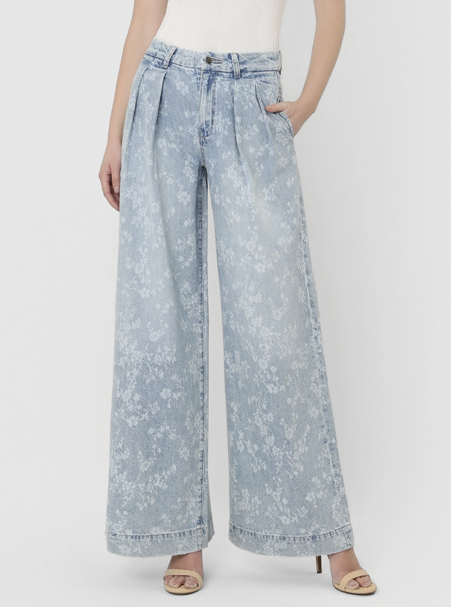 Light blue floral-patterned wide-leg jeans worn by a person on a white background