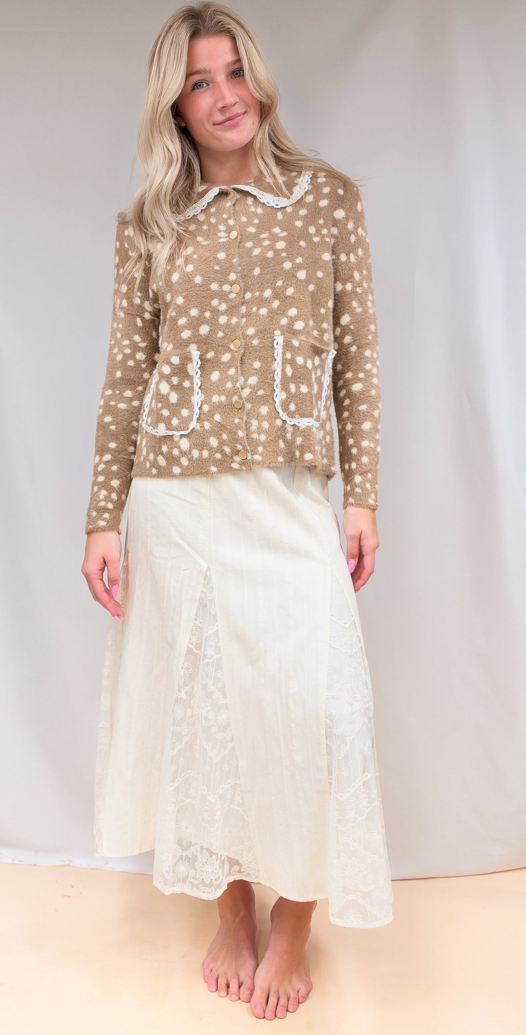 Woman wearing fawn print jacket top with lace detail maxi skirt on plain background