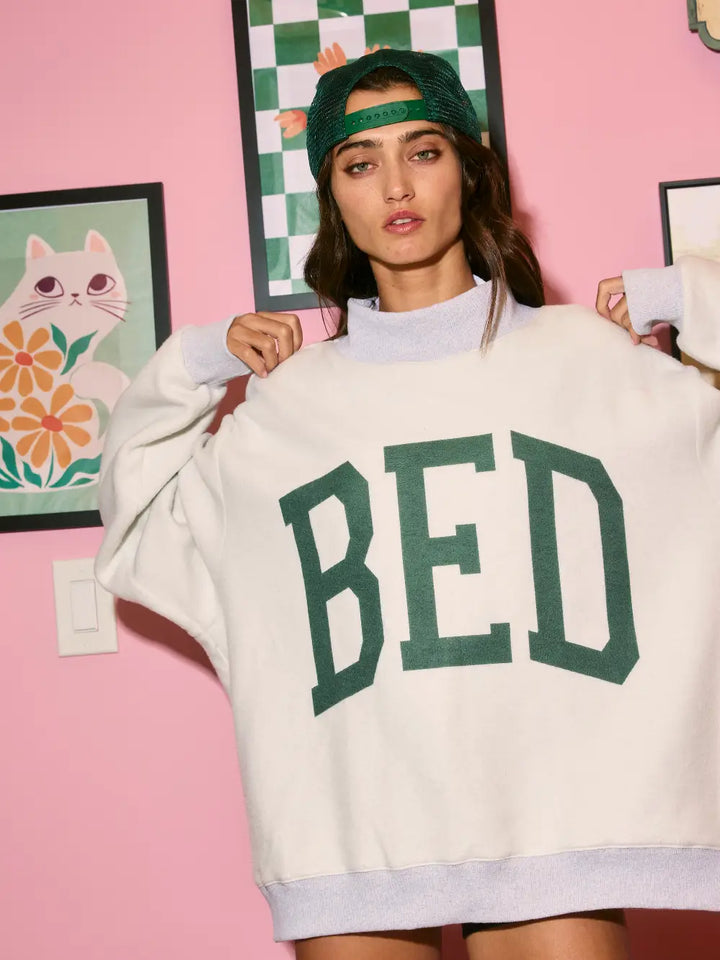 Person wearing a oversized sweatshirt with &