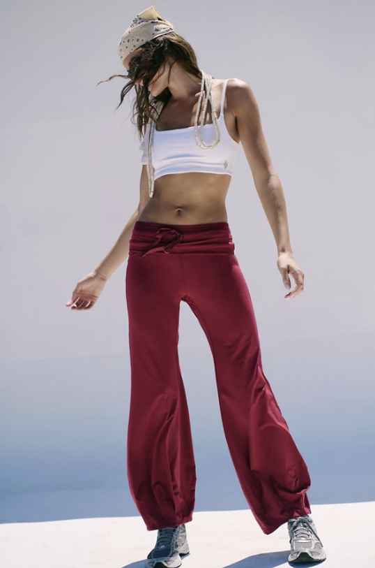 Woman wearing red pants and white bra outdoors