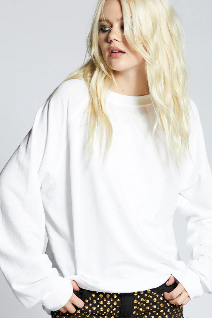 Person wearing a white sweatshirt with a plain background