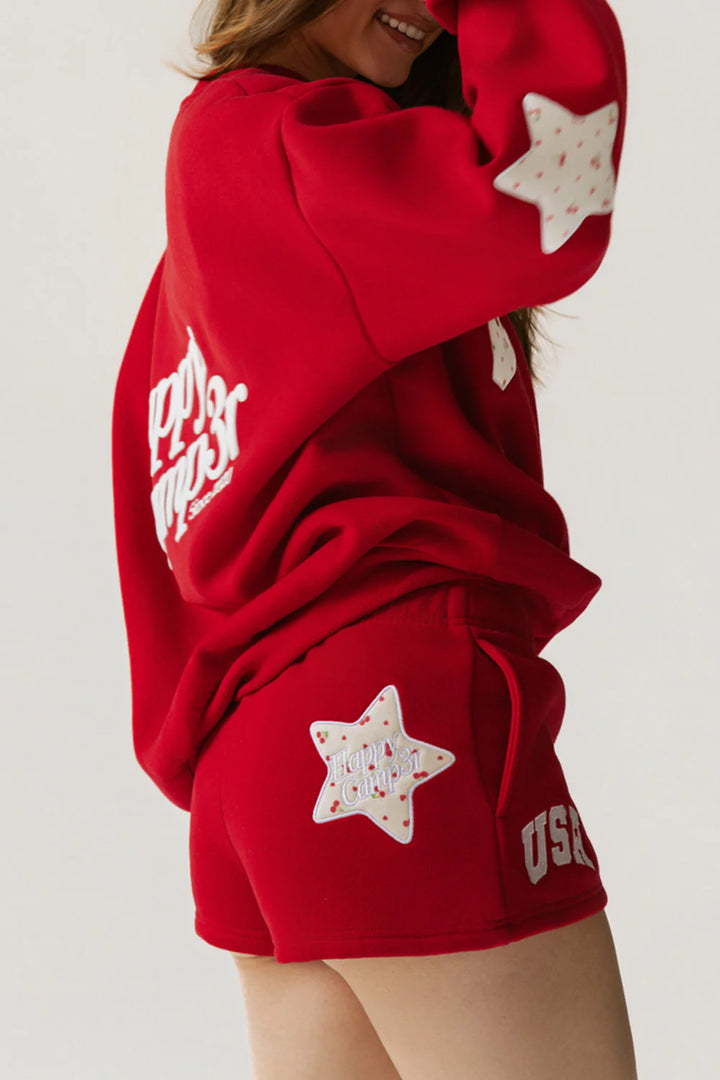 Red outfit with star patterns and text on a plain background