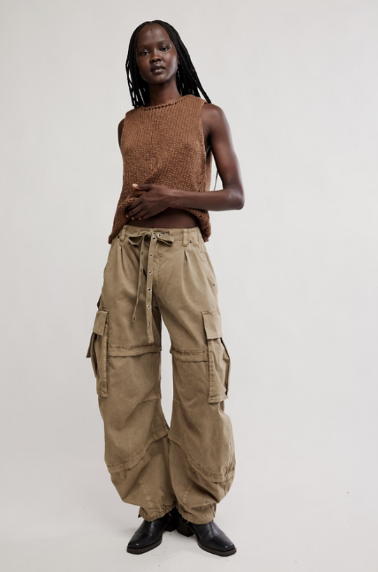 Woman wearing khaki barrel cargo pant and brown knit tank on white background