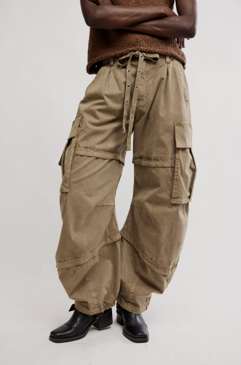 Woman wearing khaki barrel cargo pant and brown knit tank on white background