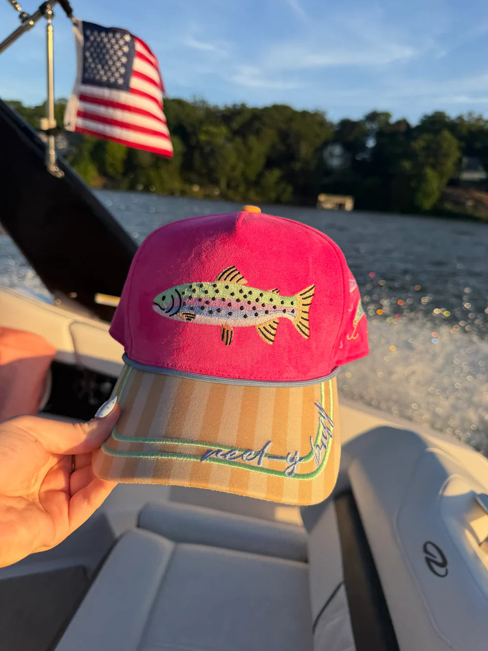 Pink trucker hat with embroidered fish on boat