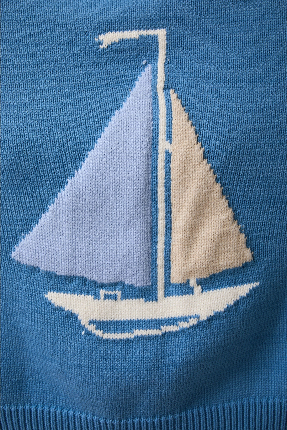 Close up of blue sweater with boat on it