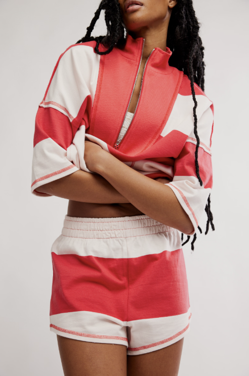 Woman wearing matching red and white stripe set on white background