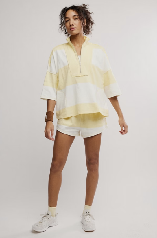 Woman wearing matching yellow and white stripe set on white background