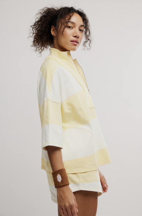 Woman wearing matching yellow and white stripe set on white background