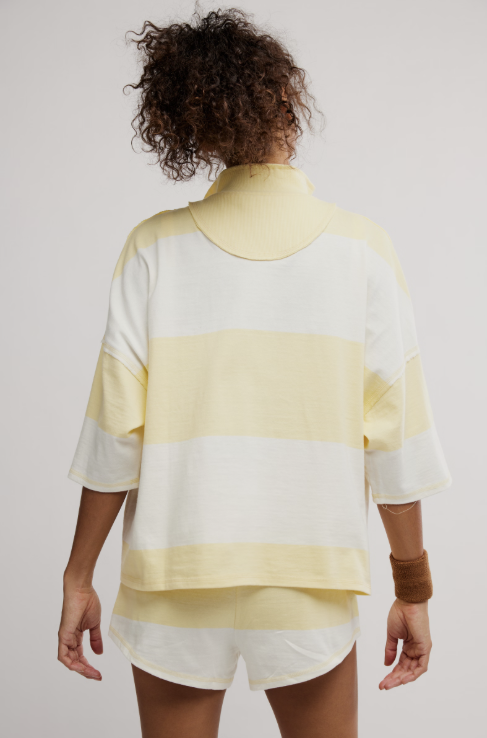 Woman wearing matching yellow and white stripe set on white background