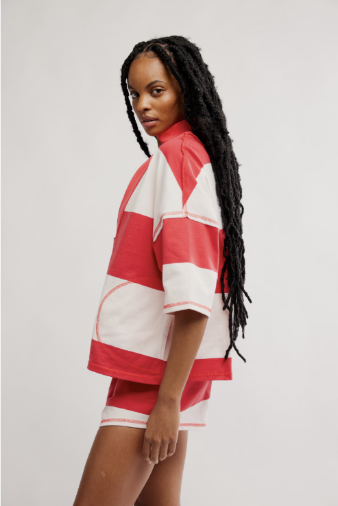 Woman wearing matching red and white set on white background