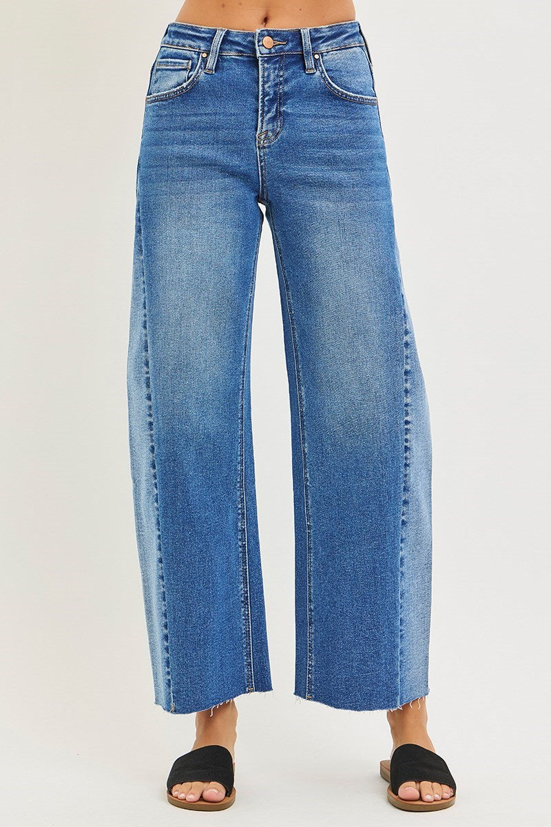 Blue jeans worn by a person on a white background