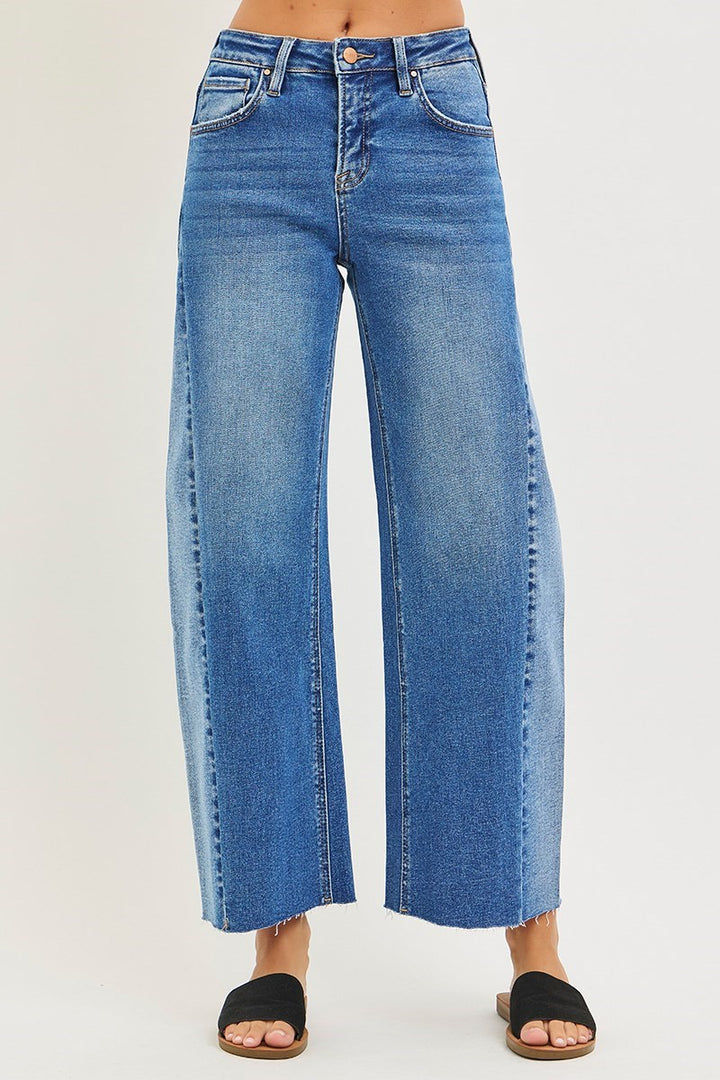 Blue jeans worn by a person on a white background