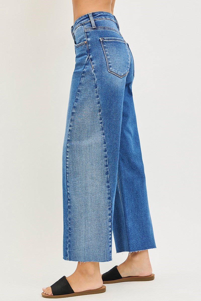 Blue jeans worn by a person on a white background