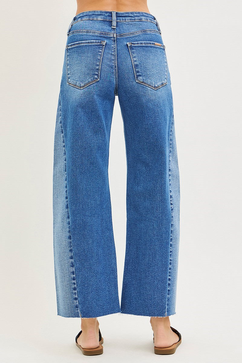 Blue jeans worn by a person on a white background