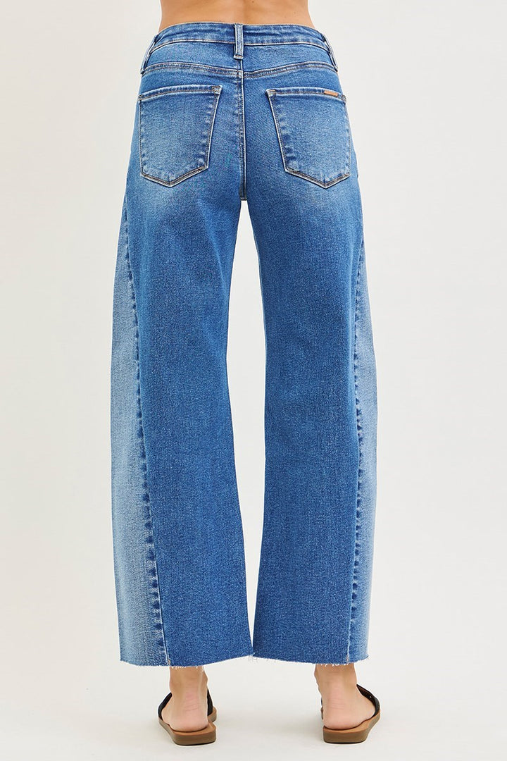 Blue jeans worn by a person on a white background