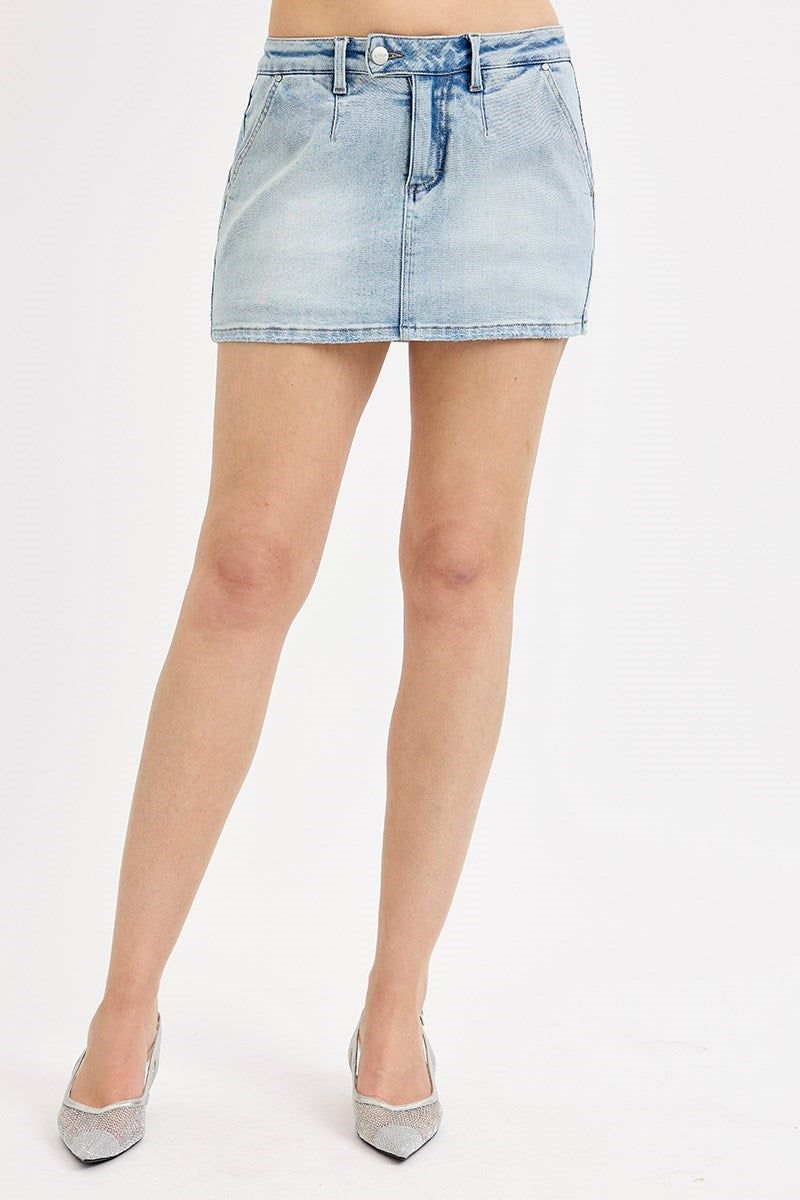 Light blue denim skirt worn by a person on a white background