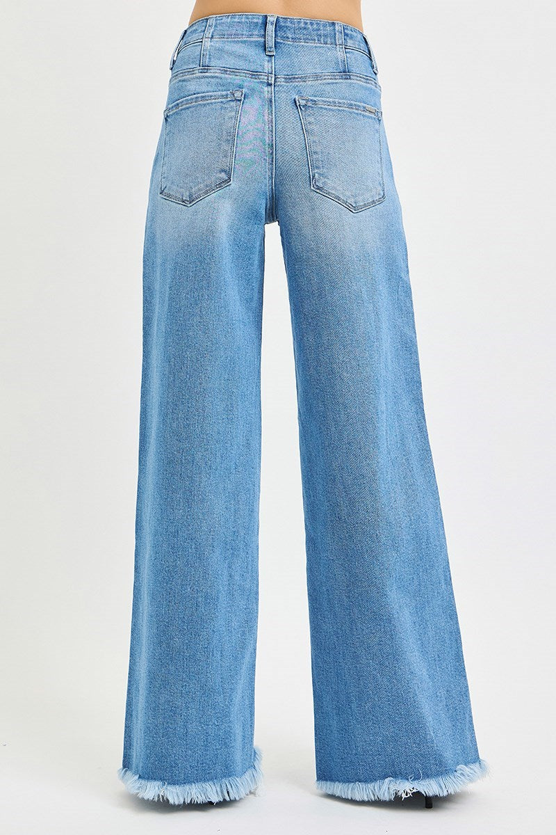 Light blue jeans with frayed hems on a white background
