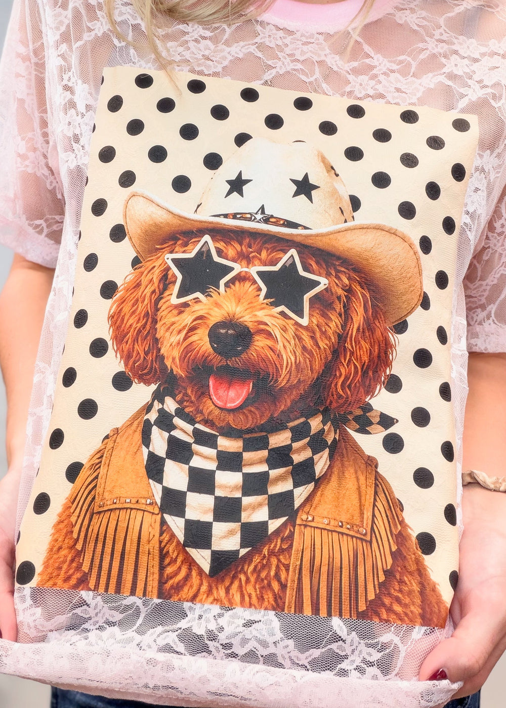 Woman wearing pink lace tee with poodle western graphic on front