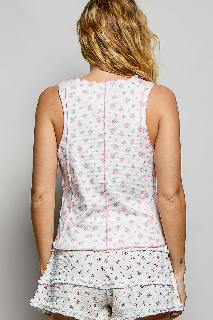 Woman wearing a matching floral top and shorts set on a plain background
